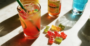 Colorful cortisol cocktail and gummy bears on a lively tabletop, evoking a dopamine-boosting vibe with vibrant, stress-relief imagery.