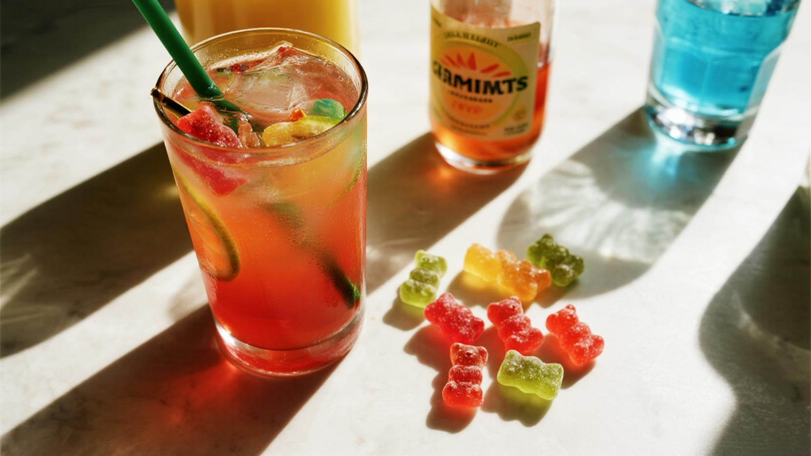 Colorful cortisol cocktail and gummy bears on a lively tabletop, evoking a dopamine-boosting vibe with vibrant, stress-relief imagery.
